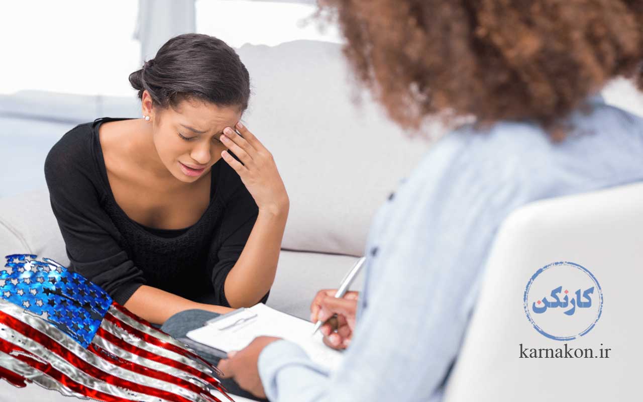 بازار کار روانشناسی در خارج از کشور (آمریکا). روانشناس زن در حال نوشتن شرح حال مراجعه کننده زن با پرچم آمریکا